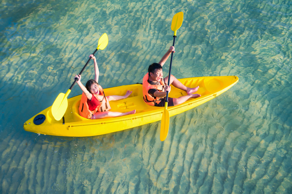 Two kids kayaking in the sea